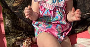 Avery joined the competition — help win amazing prizes! apparel, baby, blanket, camo_pattern, child, clapping, cute, expression, footwear, happy, headband, indoors, infant, joyful, person, pink, playtime, romper, sitting, smiling