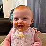 baby, child, infant, high_chair, bib, food_smear, smiling, red_hair, blue_eyes, indoor, home, furniture, curtains, deer_skull, wall_decor, cute, happy, portrait, person, sitting
