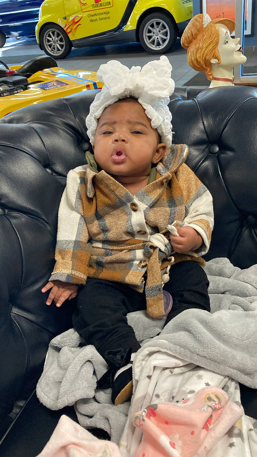 Branniah is registered to the contest to win money with this photo: baby, child, comfort, event, family_car, fun, fur, headgear, headwear, leisure, luxury_vehicle, motor_vehicle, people, person, public_space, sitting, street, tire, toddler, wheel