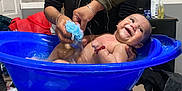 Derek Caleth is registered to the contest to win money with this photo: baby, bath_time, bathtub, blue_tub, bracelet, care, child, cleaning, furniture, hands, happy, indoor, parent, person, playful, room, skin, smiling, sponge, water