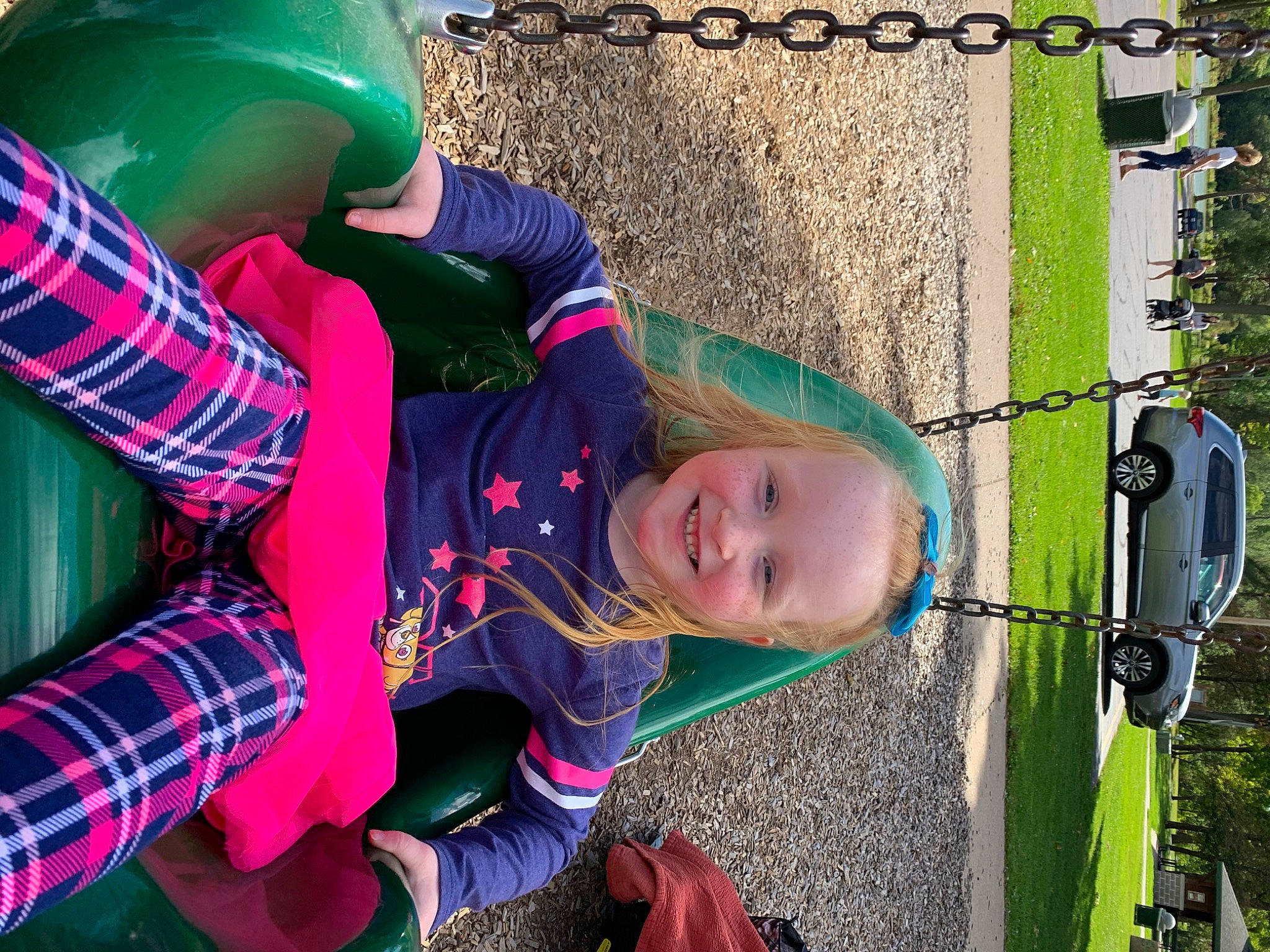 Izabel is registered to the contest to win money with this photo: child, design, grass, green, joy, outdoor_play_equipment, pattern, person, photography, plaid, plant, play, playground, public_space, smile, toddler, tree