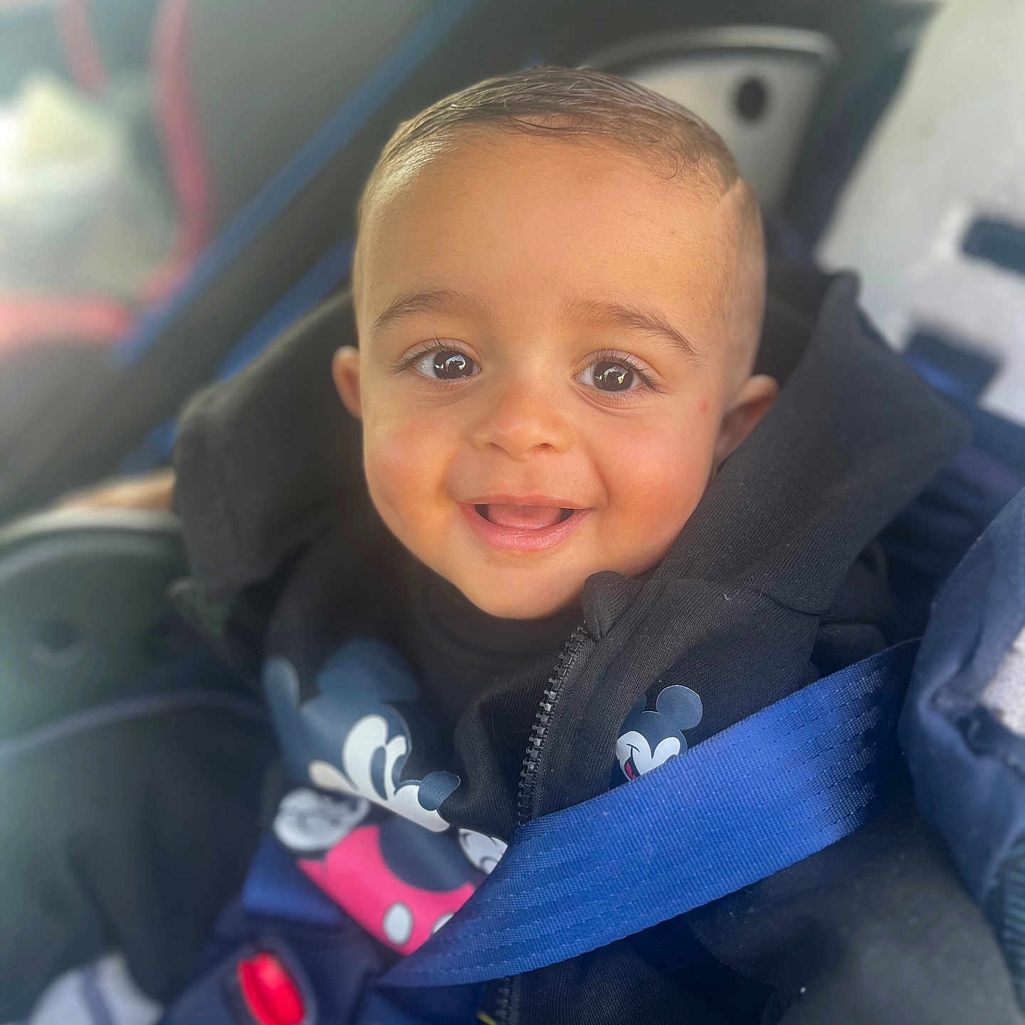 Khemys a rejoint le concours — aidez-le/la à gagner de superbes lots ! baby, black_jacket, bright_eyes, car_interior, car_seat, child, closeup, clothing, cute, face, happy, hoodie, infant, mickey_mouse, person, portrait, safety, seatbelt, smiling, young_child