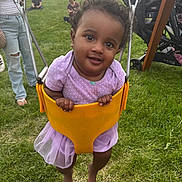 Sariyah is registered to the contest to win money with this photo: baby, child, curly_hair, event, family, festival, fun, grass, happy, outdoor, park, person, playground, purple_outfit, smile, summer, swing, toddler, tutu_skirt, yellow_swing