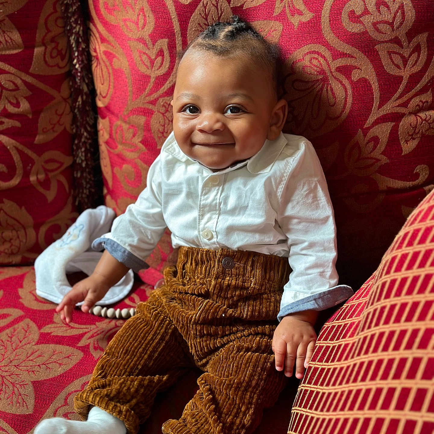 Ethan is registered to the contest to win money with this photo: baby, bodypart, clothing, couch, cushion, face, finger, furniture, hand, happy, head, homedecor, hosiery, pants, person, photography, portrait, sitting, smile, sock