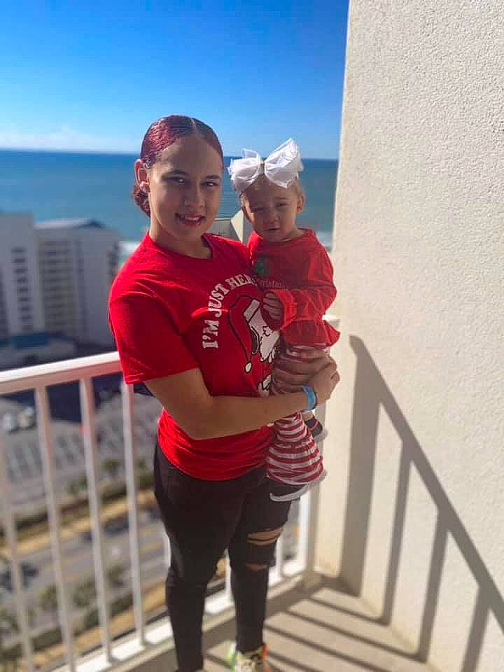 Jala is registered to the contest to win money with this photo: baby, child, event, fun, handrail, happy, holiday, joy, landscape, leisure, person, pink, recreation, shorts, sitting, sky, smile, t_shirt, toddler, tourism