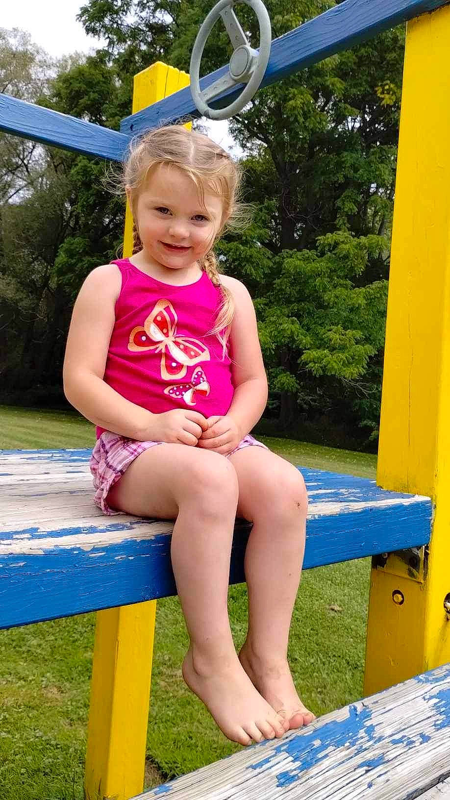 Anna joined the competition — help win amazing prizes! blue, face, facial_expression, fun, grass, green, happy, joy, leisure, light, people_in_nature, person, photograph, pink, recreation, smile, standing, summer, thigh, toddler