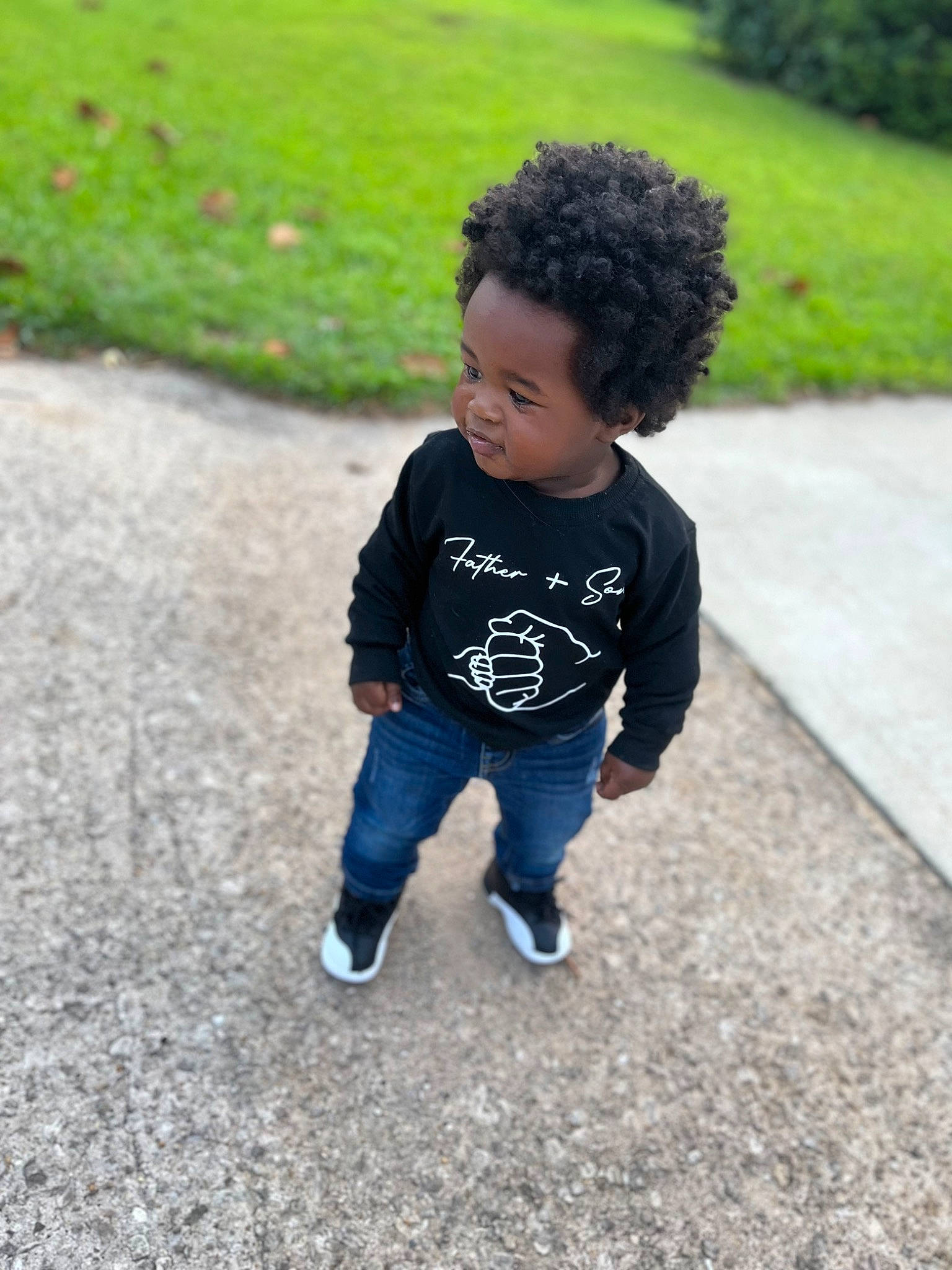 Kacey is registered to the contest to win money with this photo: asphalt, baby, baby_toddler_clothing, chin, cool, denim, eye, face, grass, head, jeans, leaf, person, plant, public_space, recreation, road_surface, sleeve, t_shirt, toddler