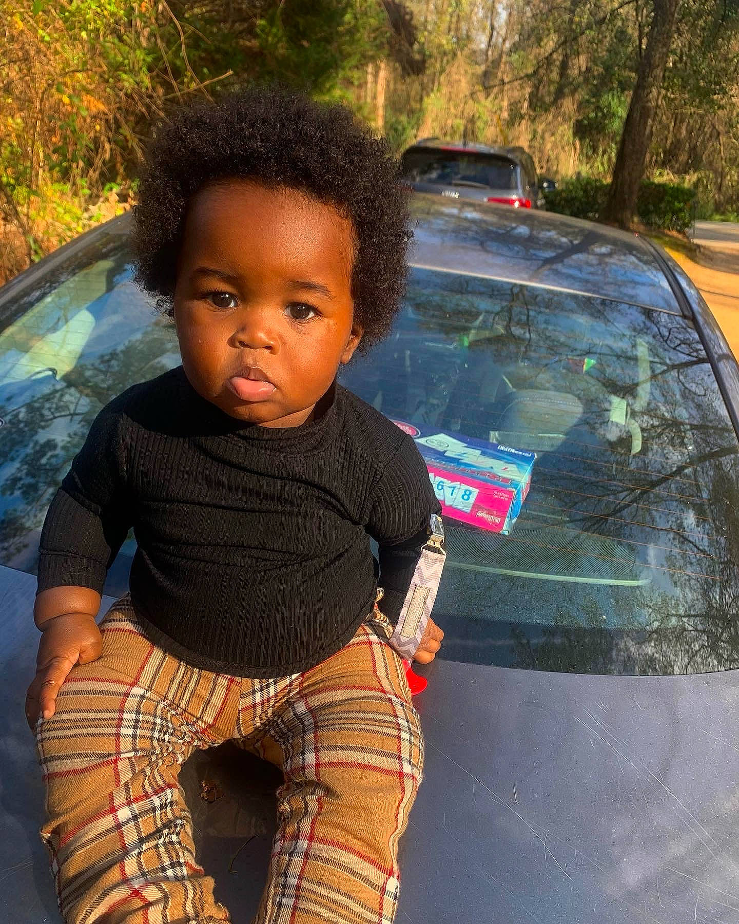 Kacey joined the competition — help win amazing prizes! automotive_design, automotive_exterior, automotive_lighting, automotive_tire, car, cool, grass, green, hairstyle, hood, land_vehicle, leisure, motor_vehicle, person, photograph, tartan, toddler, tree, vehicle, vehicle_door