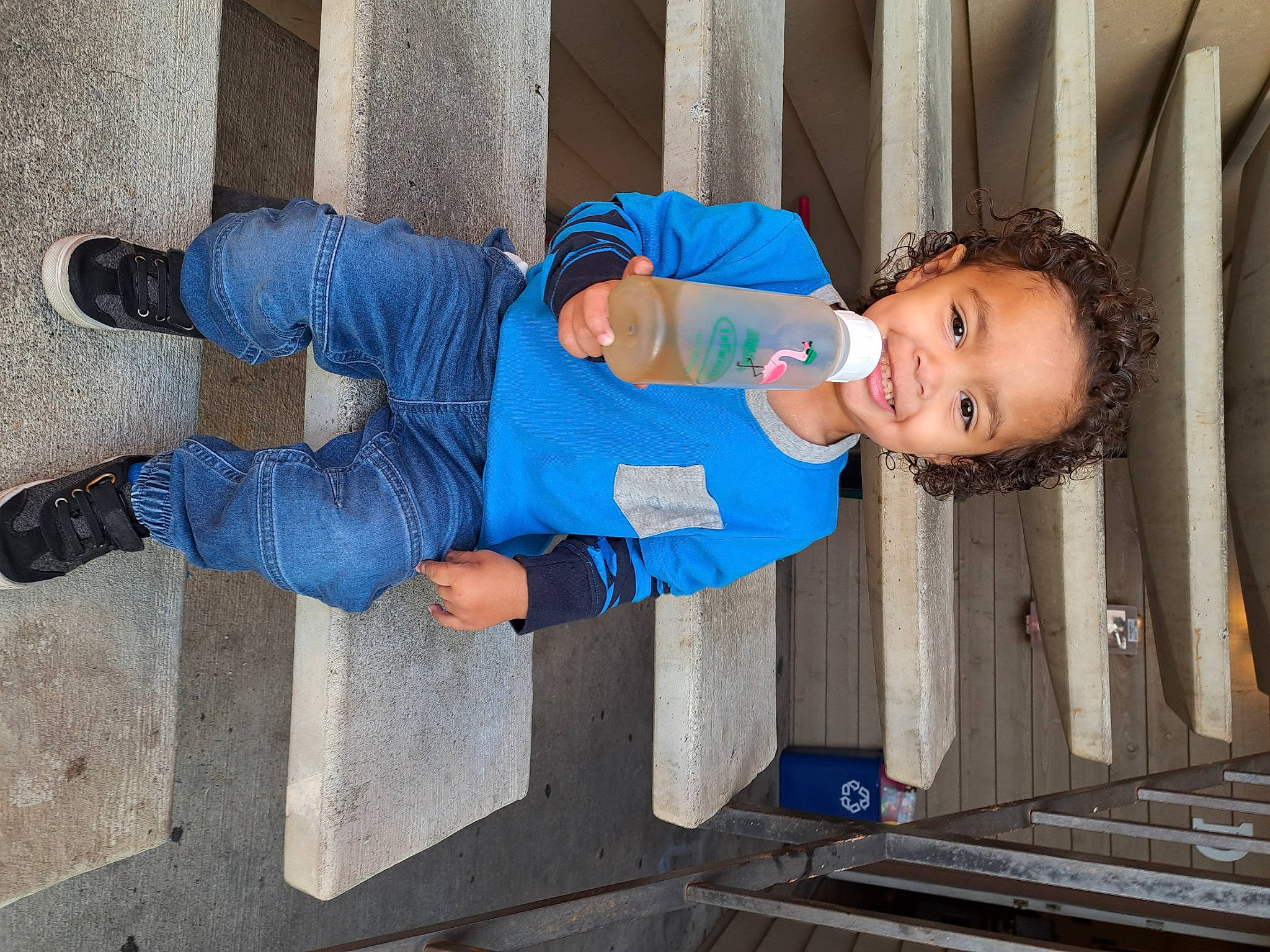 Sir is registered to the contest to win money with this photo: baby_toddler_clothing, child, composite_material, concrete, denim, elbow, electric_blue, fun, happy, hat, human_leg, joy, leisure, person, sleeve, smile, standing, thigh, toddler, walking_shoe