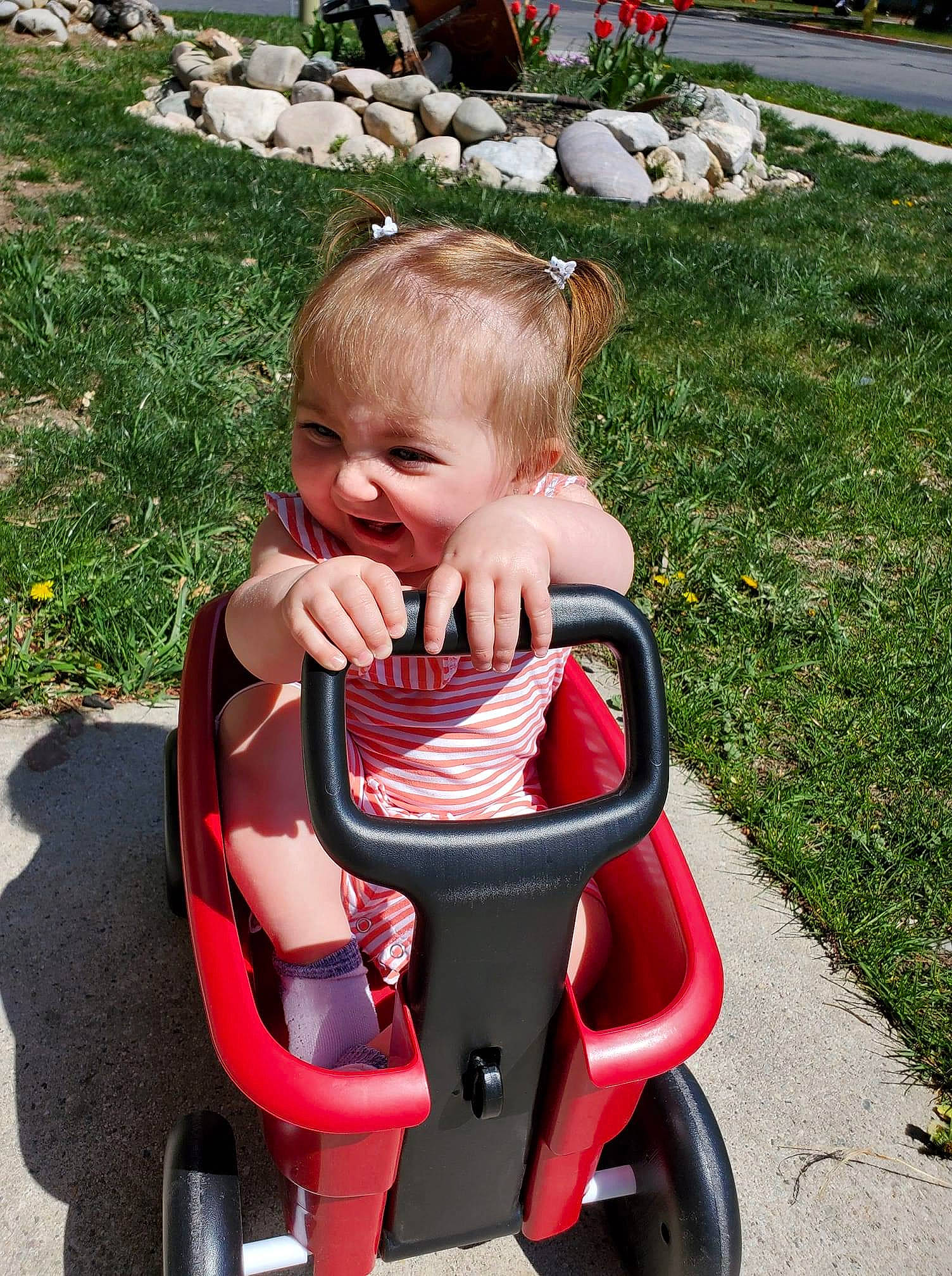 Lilith is registered to the contest to win money with this photo: baby, baby_carriage, baby_products, baby_toddler_clothing, child, fun, grass, green, happy, lawn, leisure, person, plant, recreation, riding_toy, sitting, smile, snapshot, toddler, wheel
