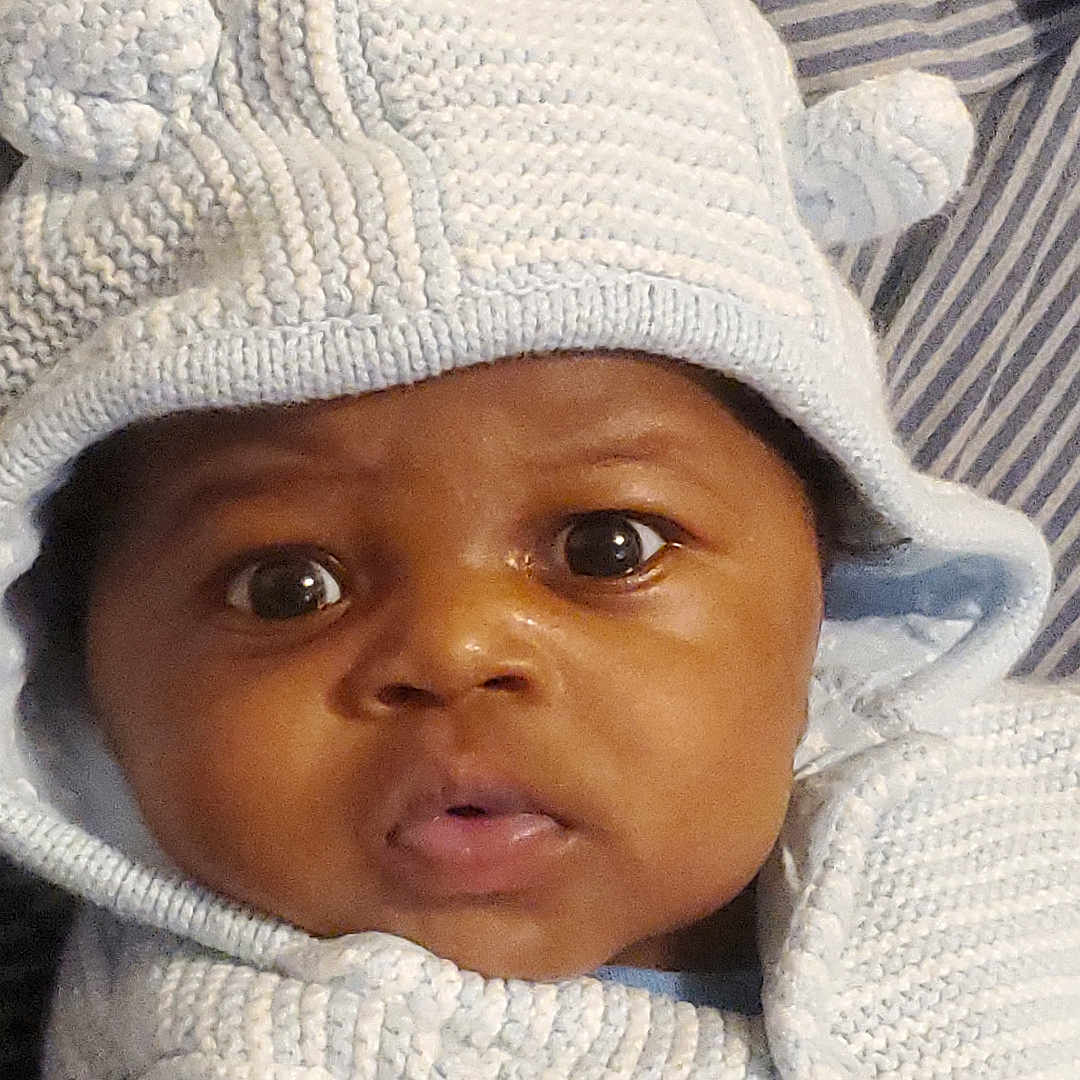 Demarco joined the competition — help win amazing prizes! baby, beanie, blanket, bonnet, cap, clothing, face, glove, happy, hat, head, hood, hoodie, knitwear, newborn, person, photography, portrait, smile, sweater