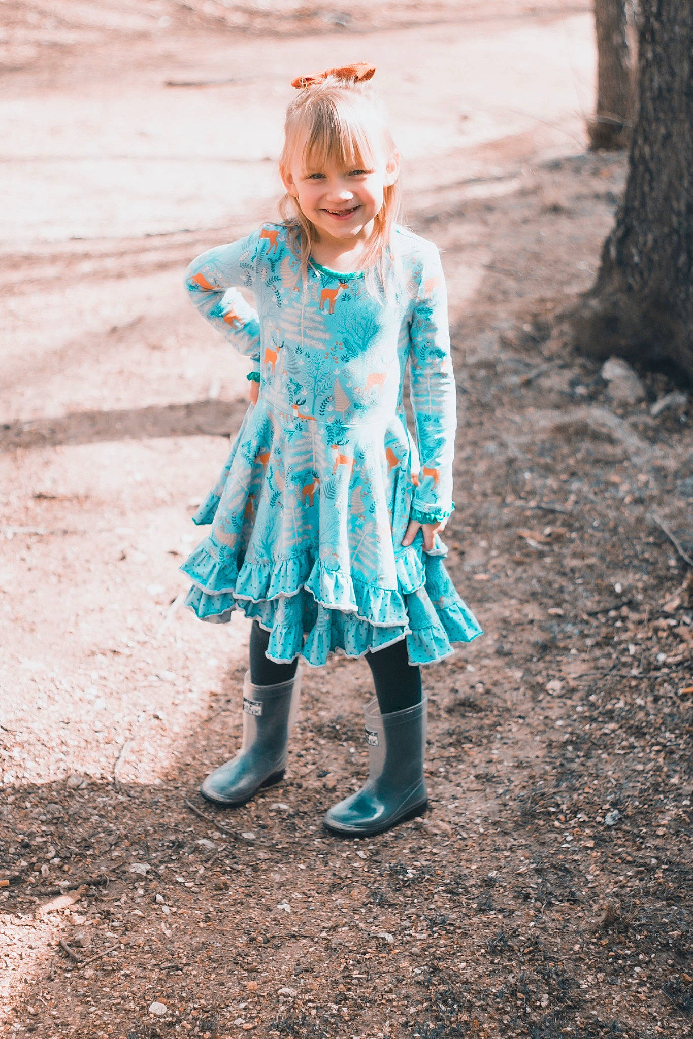 Kinsleigh is registered to the contest to win money with this photo: blond, brown_hair, child, dress, electric_blue, face, fashion_design, formal_wear, fun, grass, happy, headgear, joy, pattern, people_in_nature, person, plant, sleeve, toddler, tree
