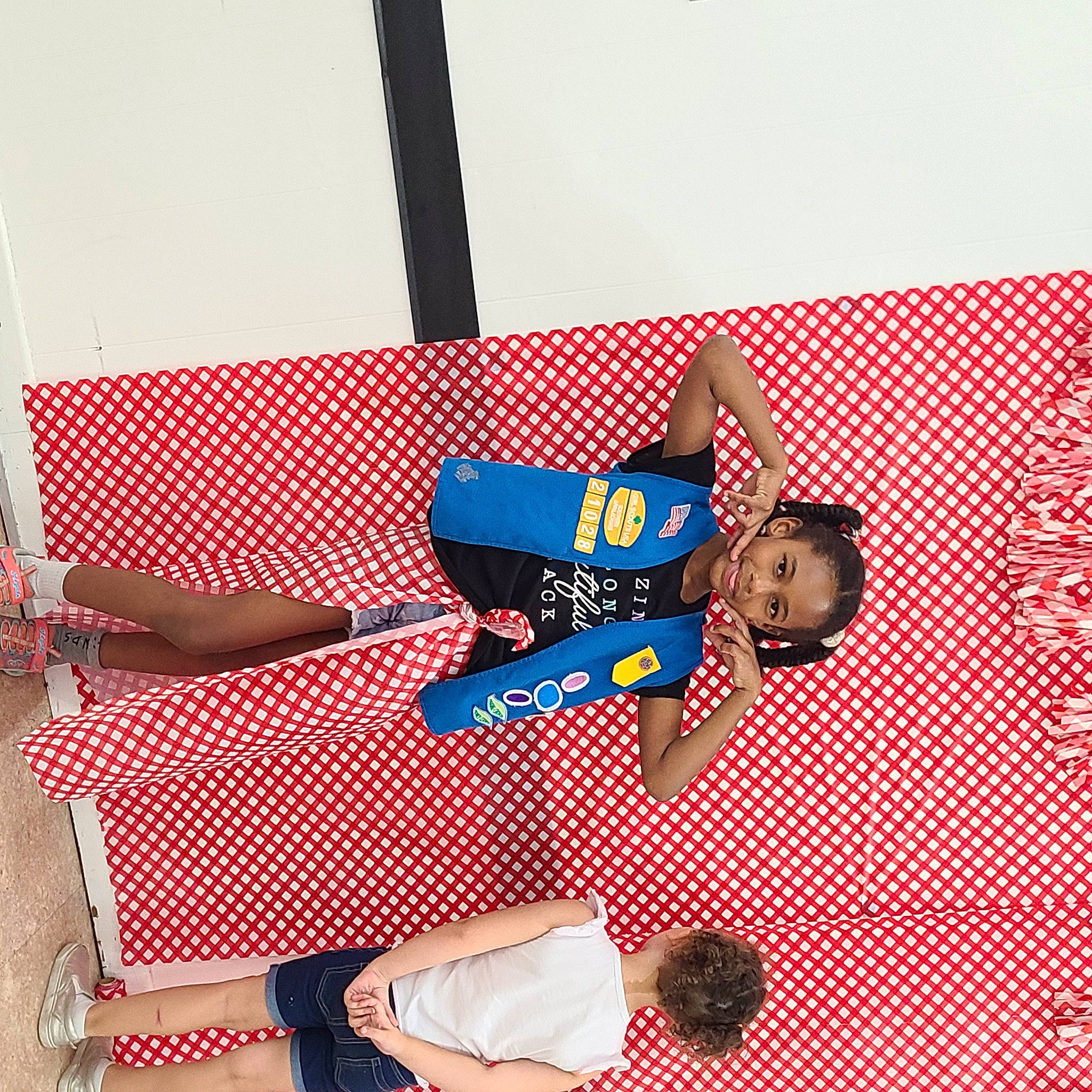 Nicole is registered to the contest to win money with this photo: art, carmine, elbow, electric_blue, fashion_accessory, fictional_character, font, fun, graphics, human_leg, joy, knee, leisure, pattern, person, plaid, room, sandal, sleeve, tartan