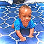 Markel joined the competition — help win amazing prizes! baby, child, smiling, blue_shirt, crawling, bed, bedspread, pattern, indoor, happy, cute, infant, person, young_child, head, hands, skin, eyes, face, pillow