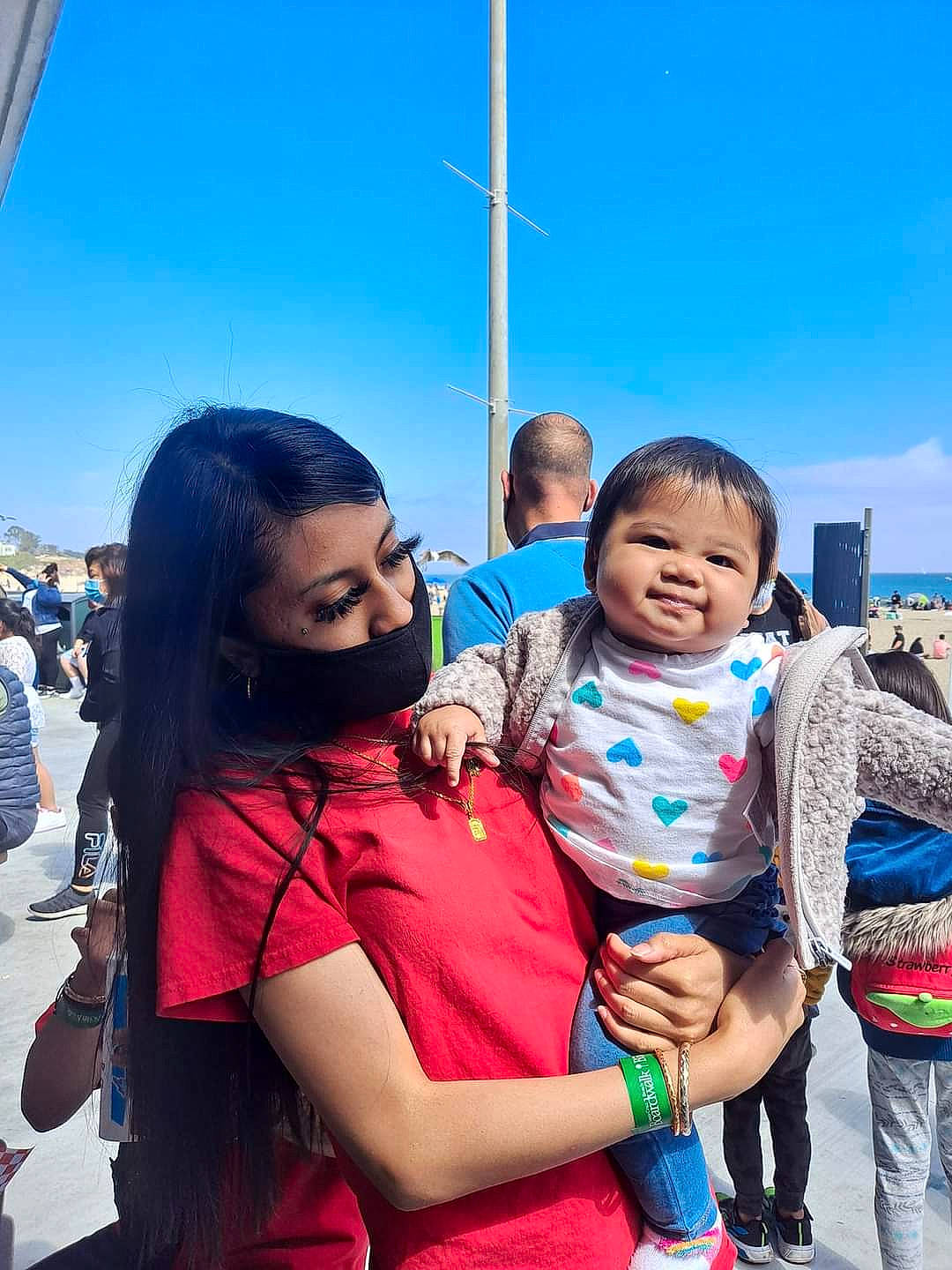 Camila is registered to the contest to win money with this photo: child, event, facial_expression, flag, friendship, fun, gesture, happy, interaction, joy, leisure, person, recreation, skin, sky, smile, summer, t_shirt, toddler, tradition
