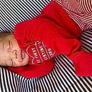 Lee joined the competition — help win amazing prizes! adorable, baby, child, closeup, cozy, cushion, cute, fabric, infant, newborn, peaceful, portrait, red_clothing, resting, sleep, sleeping, small, soft, striped_background, valentines_day