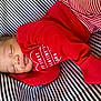 adorable, baby, child, closeup, cozy, cushion, cute, fabric, infant, newborn, peaceful, portrait, red_clothing, resting, sleep, sleeping, small, soft, striped_background, valentines_day