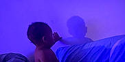 Lee joined the competition — help win amazing prizes! baby, child, shadow, bed, blanket, purple_light, indoor, silhouette, wall, curiosity, soft_light, person, infant, quiet, touch, sleeping_area, calm, dark, comfort, exploration