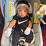 Lee joined the competition — help win amazing prizes! baby, infant, car_seat, nike, black_clothing, mittens, hat, socks, toy, elephant_toy, gray_car_seat, sitting, child, cute, indoors, portrait, looking_at_camera, comfortable, clothing, accessory