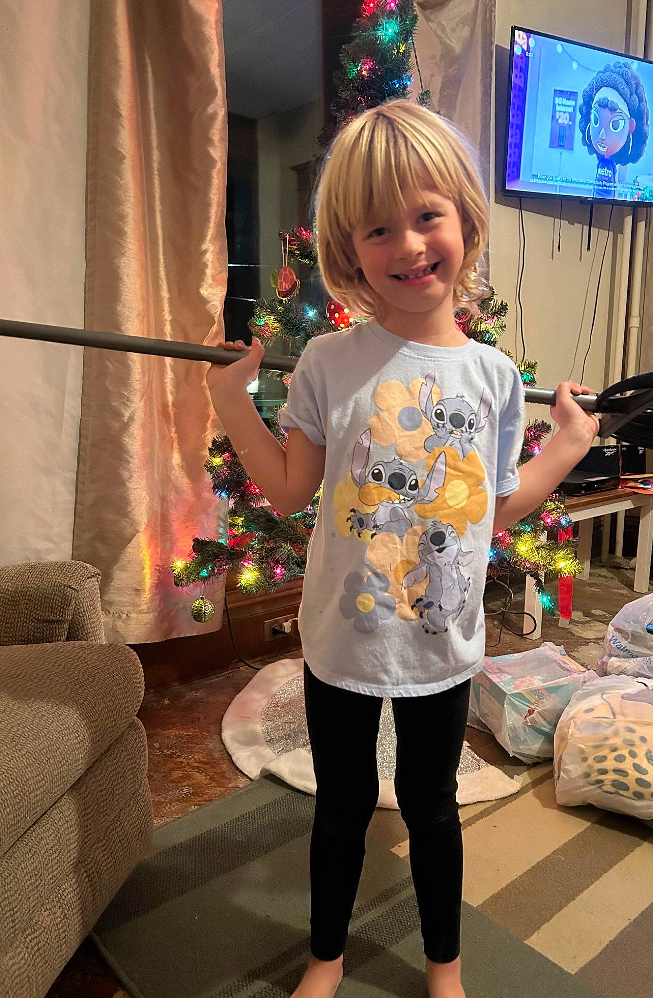 Savannah is registered to the contest to win money with this photo: child, curtain, event, flooring, fun, happy, holiday, human_leg, joint, joy, leg, person, plant, shoulder, sleeve, smile, snapshot, t_shirt, television, thigh