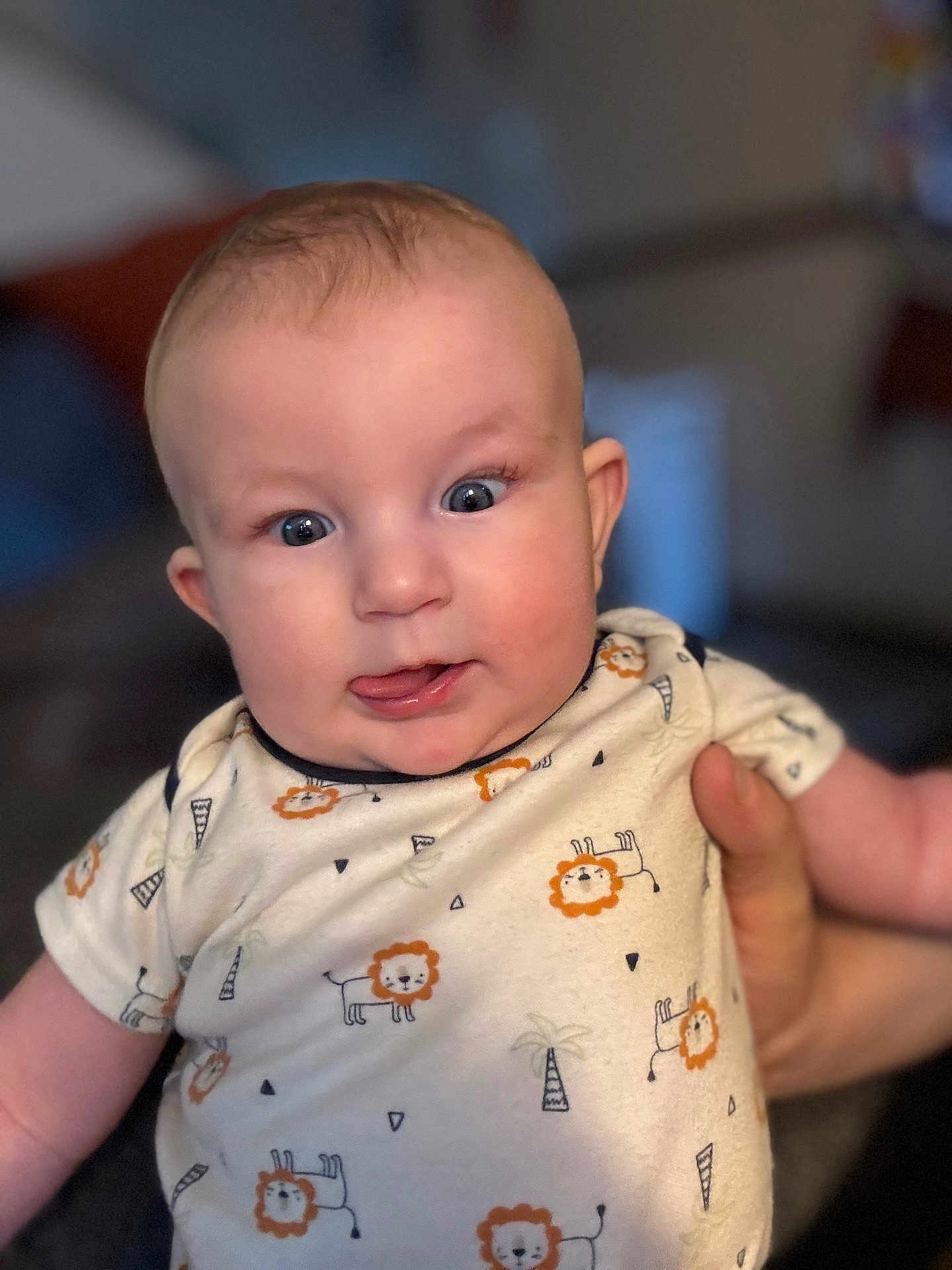 Wyatt joined the competition — help win amazing prizes! baby, child, infant, onesie, lion_print, tongue, face, hand, cute, expression, indoor, person, apparel, short_sleeve, skin, young, portrait, smiling, playful, human