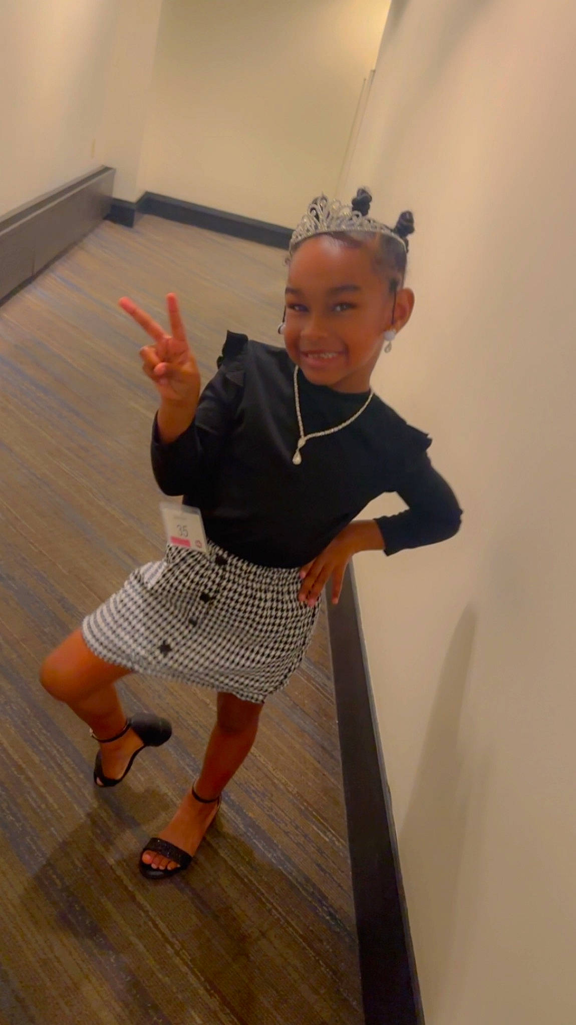 Nalani is registered to the contest to win money with this photo: baby_toddler_clothing, child, elbow, floor, flooring, foot, fun, happy, hardwood, human_leg, joy, knee, pattern, person, room, sandal, sleeve, smile, sock, thumb