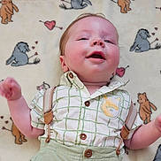 Rockwell joined the competition — help win amazing prizes! baby, infant, smiling, lying_down, shirt, suspenders, blanket, cartoon_animals, hearts, cute, happy, child, portrait, indoor, soft_texture, cozy, clothing, young_child, face, playful
