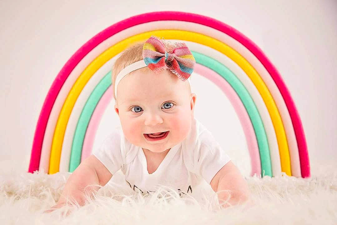 Jane joined the competition — help win amazing prizes! baby, baby_laughing, baby_products, baby_toddler_clothing, child_model, colorfulness, costume_accessory, facial_expression, fun, hair_accessory, happy, headgear, headwear, person, pink, portrait_photography, rainbow, skin, stock_photography, toddler