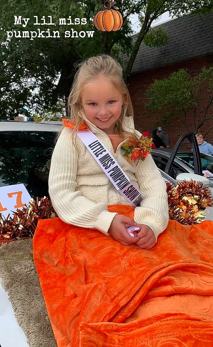 Raylynne is registered to the contest to win money with this photo: adult, advertisement, blanket, child, face, female, furniture, girl, head, lady, male, man, person, photography, plant, portrait, pottedplant, sash, sitting, student