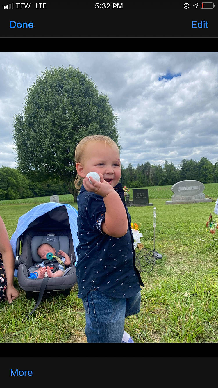Waylon is registered to the contest to win money with this photo: baby, child, cloud, fun, grass, grass_family, grassland, happy, landscape, lawn, leisure, meadow, people_in_nature, person, plant, recreation, sitting, sky, toddler, tree