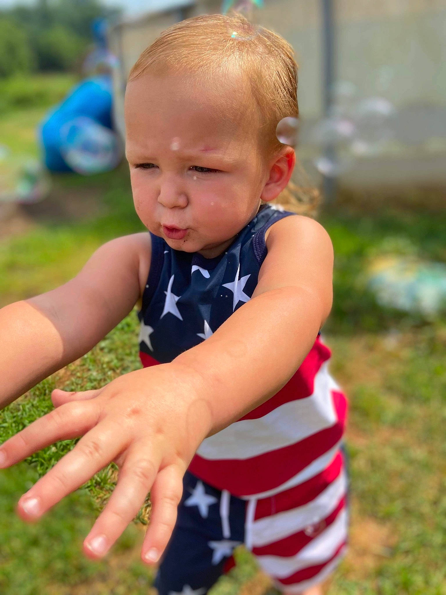 Waylon is registered to the contest to win money with this photo: arm, baby, baby_toddler_clothing, finger, fun, grass, grass_family, hand, happy, head, leaf, leisure, people_in_nature, person, plant, recreation, skin, sleeve, summer, t_shirt