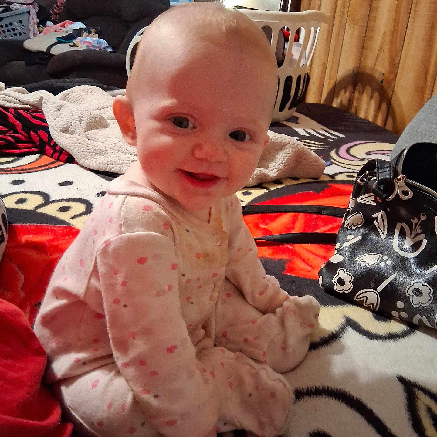Cylance joined the competition — help win amazing prizes! baby, infant, pajamas, smile, child, indoor, blanket, pattern, furniture, laundry_basket, clothing, person, home, wood_paneling, bag, toy, floor, happy, seated, cozy