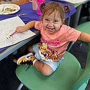 Sarefina joined the competition — help win amazing prizes! child, toddler, smiling, pigtails, pink_shirt, coloring, crayon, paper, chair, green_chair, table, shoes, sneakers, indoor, classroom, happy, person, cute, drawing, playful