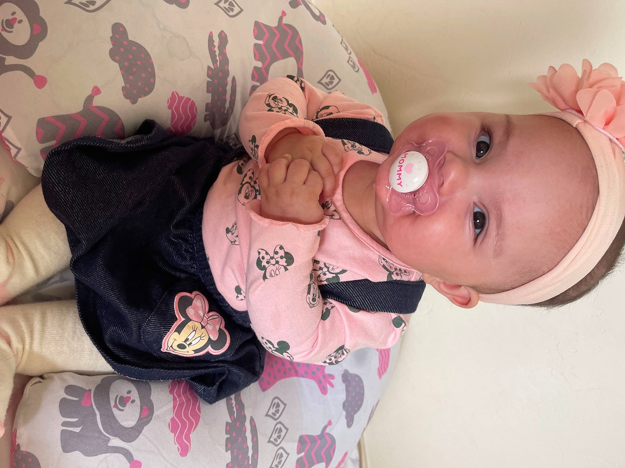 Marianna is registered to the contest to win money with this photo: arm, baby, baby_toddler_clothing, cheek, comfort, dress, eye, eyelash, finger, hand, head, human_body, lip, mouth, neck, person, pink, skin, sleeve, toddler