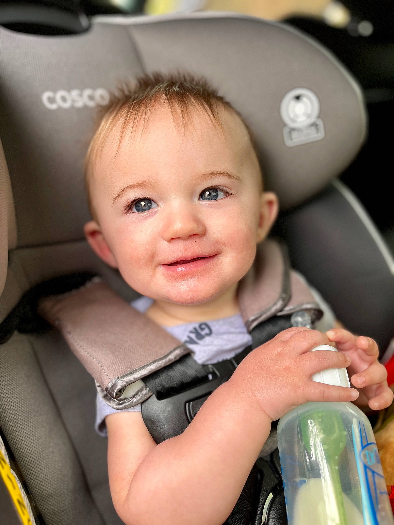 Clayton is registered to the contest to win money with this photo: auto_part, automotive_design, baby, bottle, car_seat, cheek, child, comfort, drinking, drinkware, flash_photography, happy, joy, person, photograph, plastic_bottle, skin, smile, snapshot, toddler