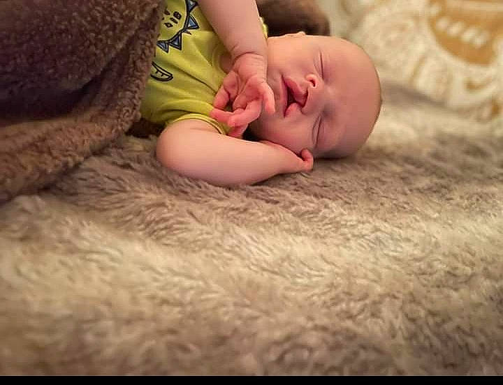 Andrew is registered to the contest to win money with this photo: baby, comfort, dress, ear, eye, flash_photography, grass, hand, happy, head, headgear, human_body, leg, mammal, nose, person, plant, skin, toddler, vertebrate