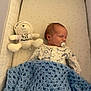 baby, newborn, sleeping, pacifier, blanket, crochet, crib, plush_toy, bear, hoodie, clothing, soft_toy, infant, bed, sleep, comfort, cute, indoor, rest, child