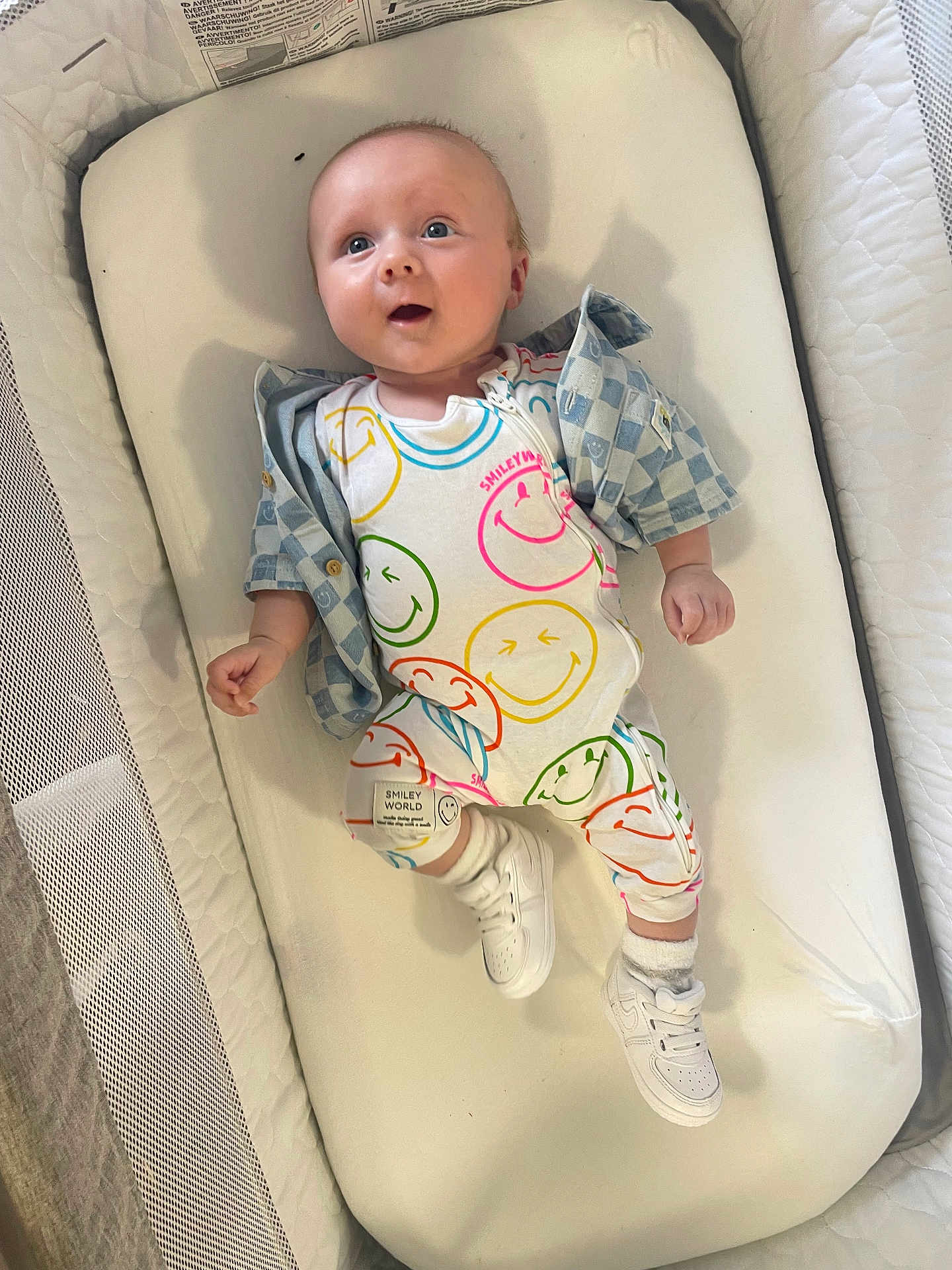 Frankie joined the competition — help win amazing prizes! baby, infant, smiling, onesie, shoes, shirt, cushion, crib, mesh, cute, child, person, footwear, clothing, happy, blue_eyes, expression, white_shoes, patterned_clothing, indoor