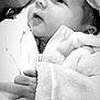 Frankie joined the competition — help win amazing prizes! baby, infant, black_and_white, close_up, hand, jacket, hat, face, portrait, newborn, warm_clothing, soft_texture, cute, expression, child, human, cozy, care, tenderness, zipped_jacket