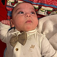 Dylan joined the competition — help win amazing prizes! baby, bed, blanket, bow_tie, cheeks, close_up, clothing, eyelashes, eyes, face, infant, lips, looking_up, monogram, pajamas, patterned_fabric, pillow, portrait, skin, soft_lighting