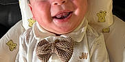 Dylan joined the competition — help win amazing prizes! baby, baby_seat, bow_tie, buttons, child, clothing, drool, eyes, face, happy, home, indoor, infant, mouth, onesie, pillow, portrait, smiling, teddy_bear_pattern, tongue