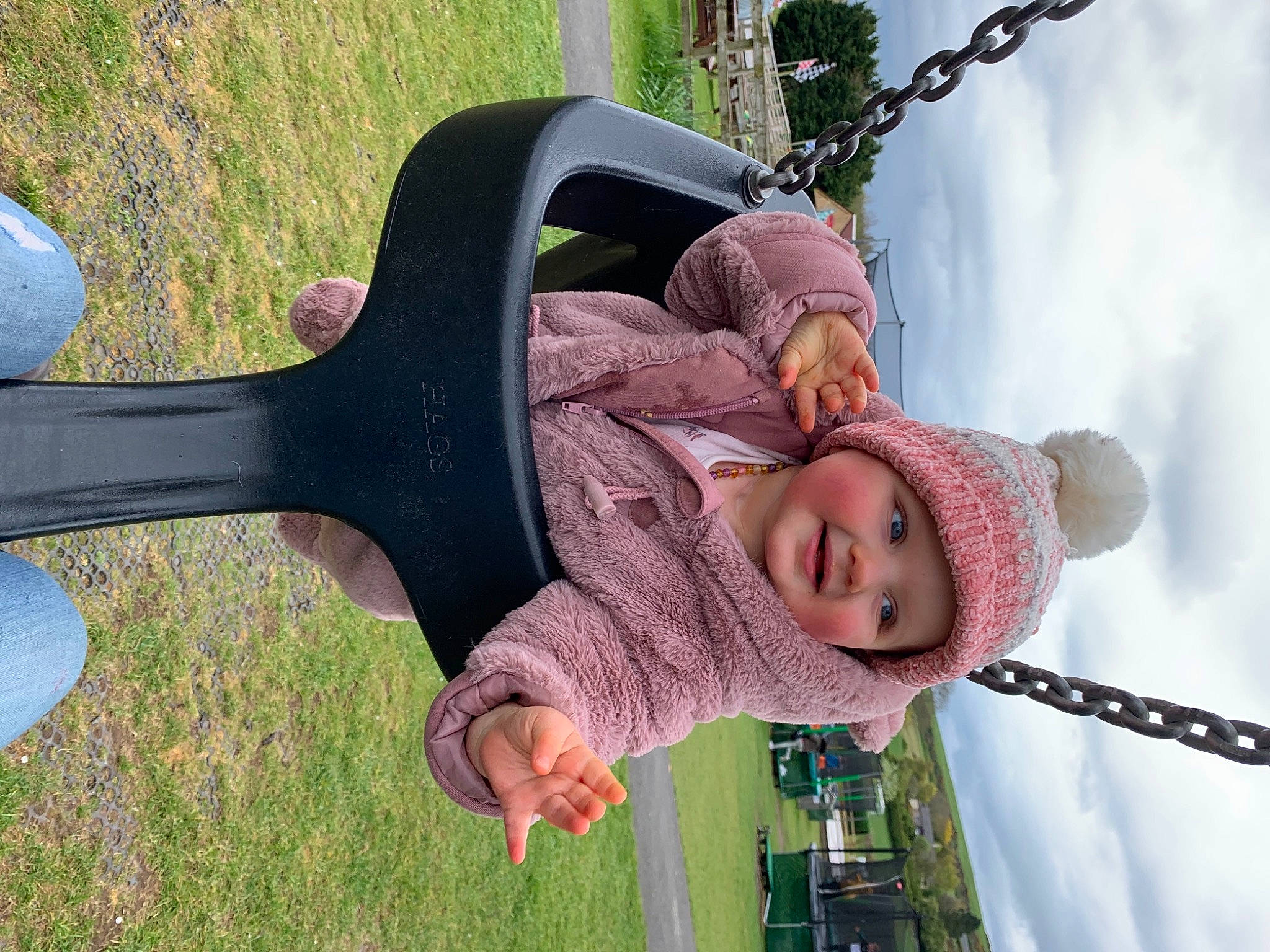 Louise is registered to the contest to win money with this photo: child, city, cloud, fun, grass, green, happy, hat, headwear, joy, leisure, outdoor_play_equipment, people_in_nature, person, plant, playground, pole, recreation, sky, smile