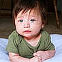 baby, blue_eyes, brown_hair, child, closeup, cushion, cute, expression, face, green_shirt, hands, indoor, infant, lying_down, person, portrait, skin, soft_light, toddler, young