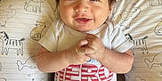 Parker joined the competition — help win amazing prizes! animal_pattern, baby, baby_boy, child, clothing, cute, eyes, face, hair, hand, happy, indoors, infant, lying_down, pants, people, pillow, portrait, shirt, smiling