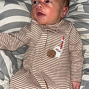 Colton joined the competition — help win amazing prizes! baby, infant, onesie, striped_clothing, milk_patch, cookie_patch, blanket, patterned_blanket, lying_down, curious_expression, hair_tuft, cozy, indoor, child, newborn, sleepwear, soft_fabric, cute, portrait, young_child