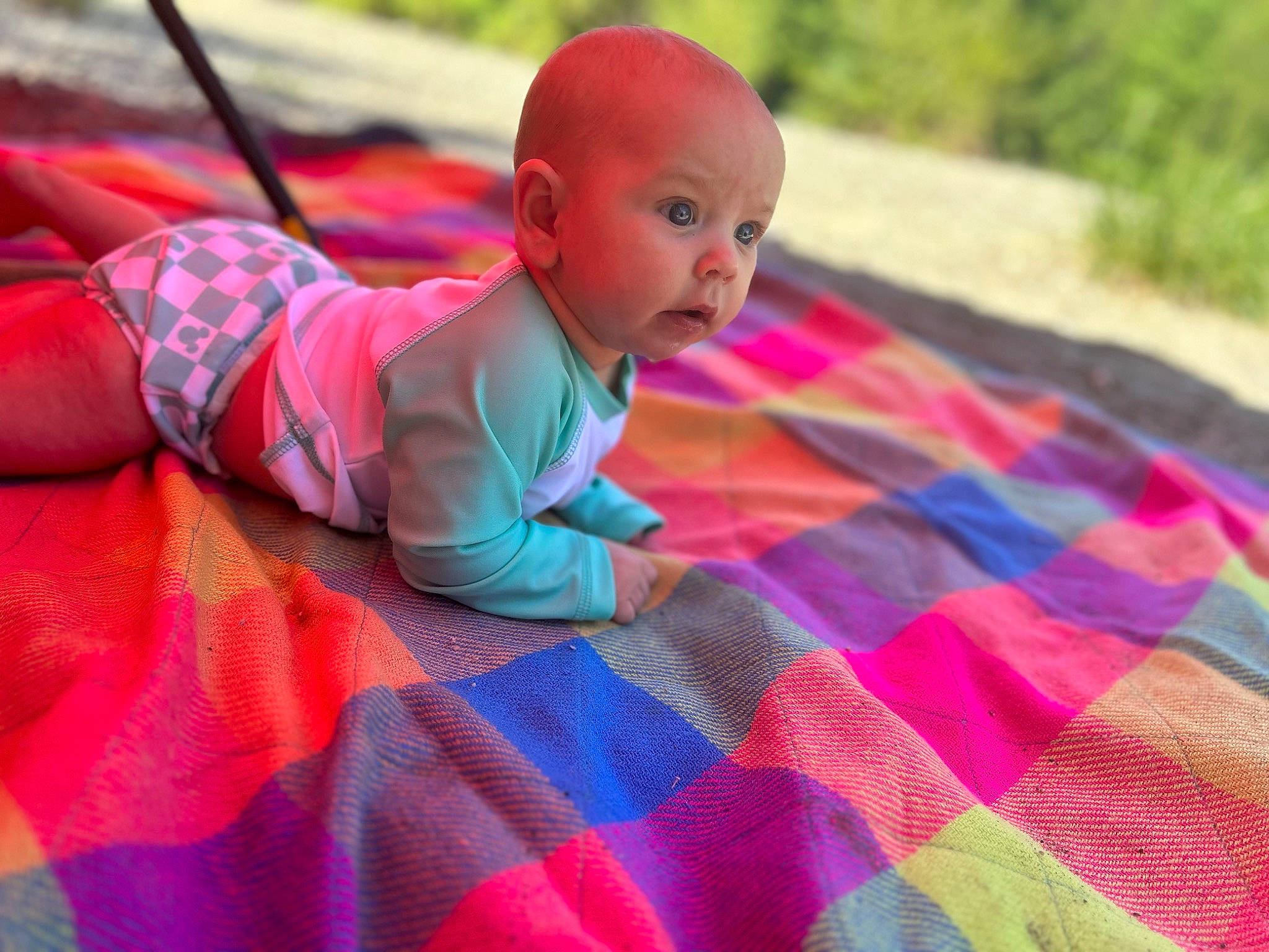 Adaline joined the competition — help win amazing prizes! baby, baby_toddler_clothing, child, flooring, fun, grass, happy, leisure, magenta, pattern, person, pink, plaid, plant, purple, recreation, sitting, surprise, t_shirt, tartan