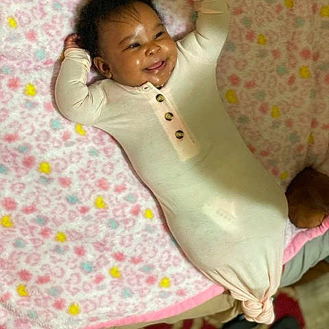 Reign is registered to the contest to win money with this photo: baby, child, linens, pink, skin, smile, textile, toddler
