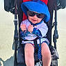 Bentlee is registered to the contest to win money with this photo: baby, stroller, blue_hat, sunglasses, smiling, child, sunny_day, outdoor, casual_clothing, footwear, pacifier, seat_belt, happy, infant, playful, summer, toy, person, baby_clothes, shade