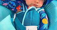 Bentlee is registered to the contest to win money with this photo: baby, child, infant, blue_hat, swimsuit, floaty, pool, water, sun_hat, relaxed, toddler, outdoor, summer, cute, sitting, colorful_clothing, sunlight, face, hand, seat