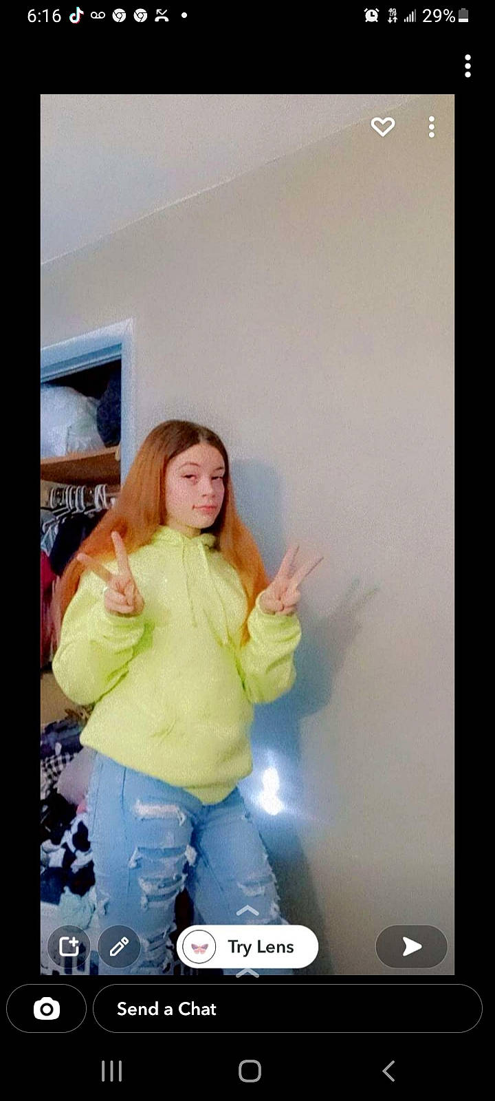 Adrianna is registered to the contest to win money with this photo: brown_hair, child, clothing, flash_photography, fun, gesture, happy, human_leg, knee, pattern, person, picture_frame, room, shelf, shoulder, sitting, sleeve, t_shirt, thigh, thumb